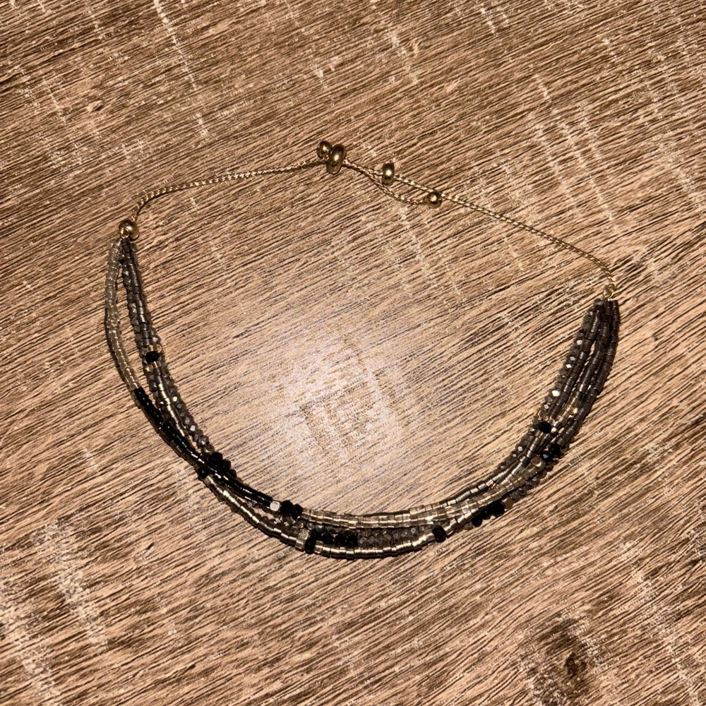 Like new gold and black beaded three layer bracelet